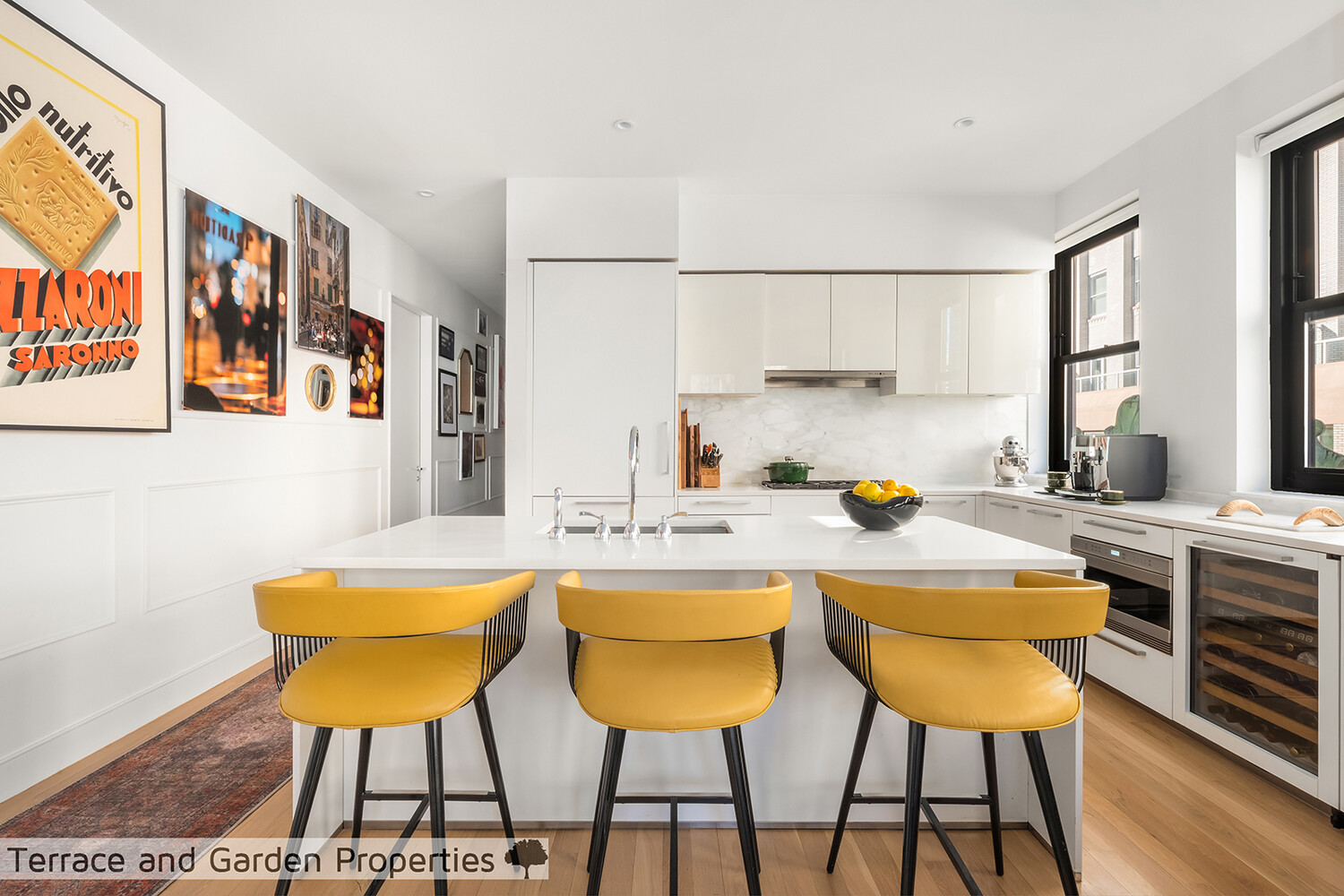 25 Broad Street, Unit PH2D Manhattan, NY 10004 - Photo 9 of 21 a kitchen with stainless steel appliances a dining table chairs and a refrigerator