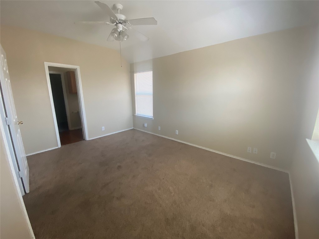 2706 Westhampton Court, Unit A Round Rock, TX 78664 - Photo 3 of 12 an empty room with windows and fan