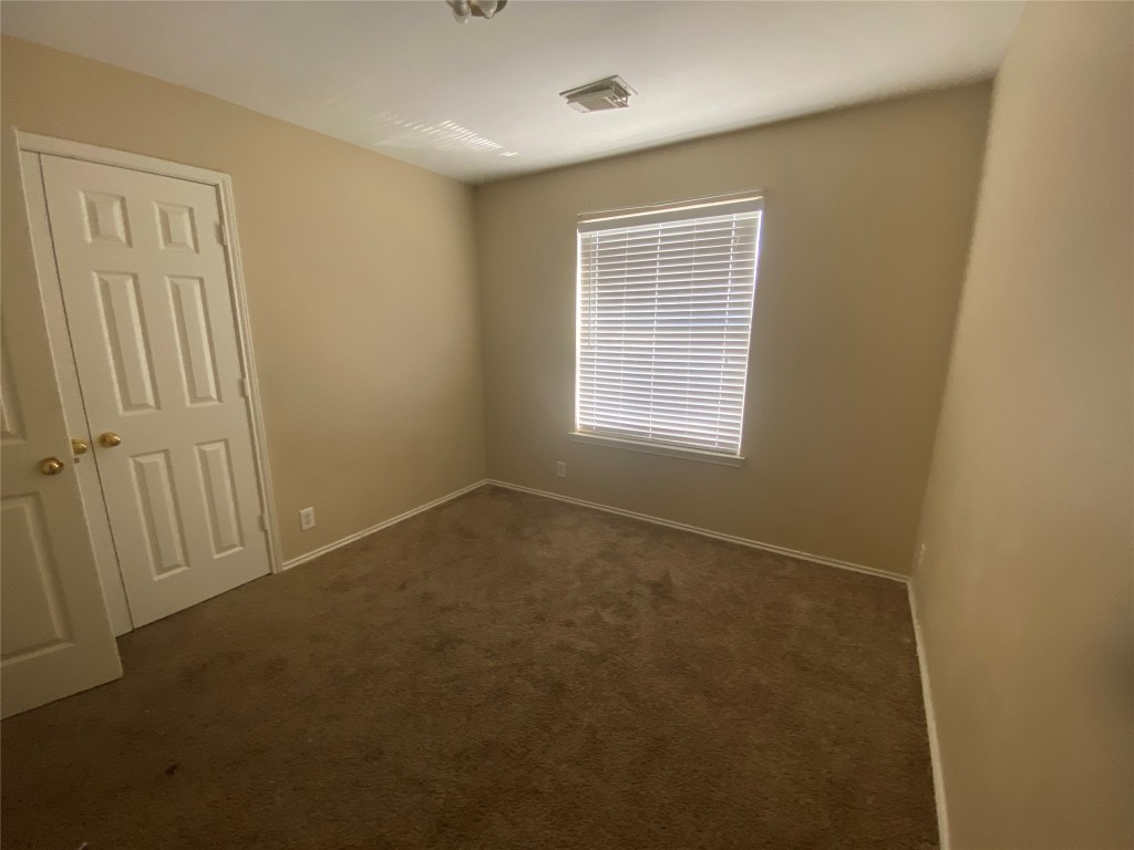 2706 Westhampton Court, Unit A Round Rock, TX 78664 - Photo 5 of 12 an empty room with windows