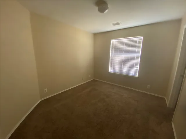 an empty room with a empty space and windows