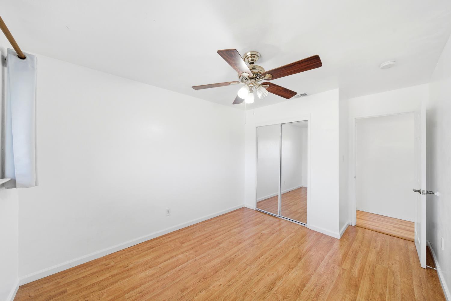 6515 West 4th Street Rio Linda, CA 95673 - Photo 31 of 97 a view of a big room with wooden floor and a ceiling fan
