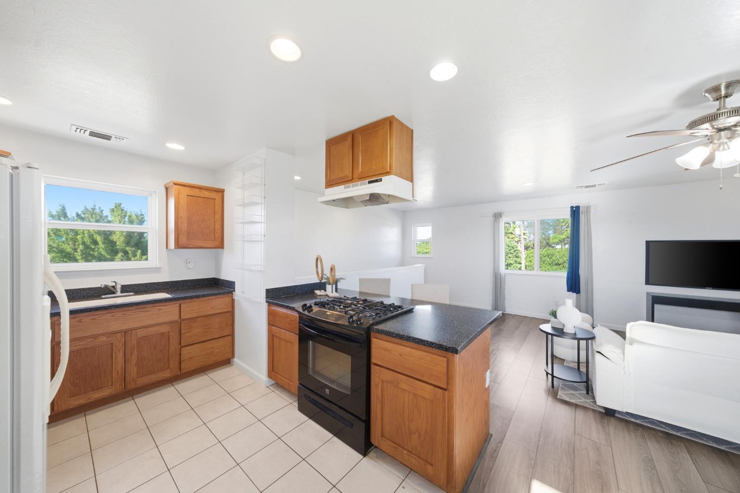 6515 West 4th Street Rio Linda, CA 95673 - Photo 35 of 97 a kitchen with stainless steel appliances granite countertop a stove a sink and a microwave