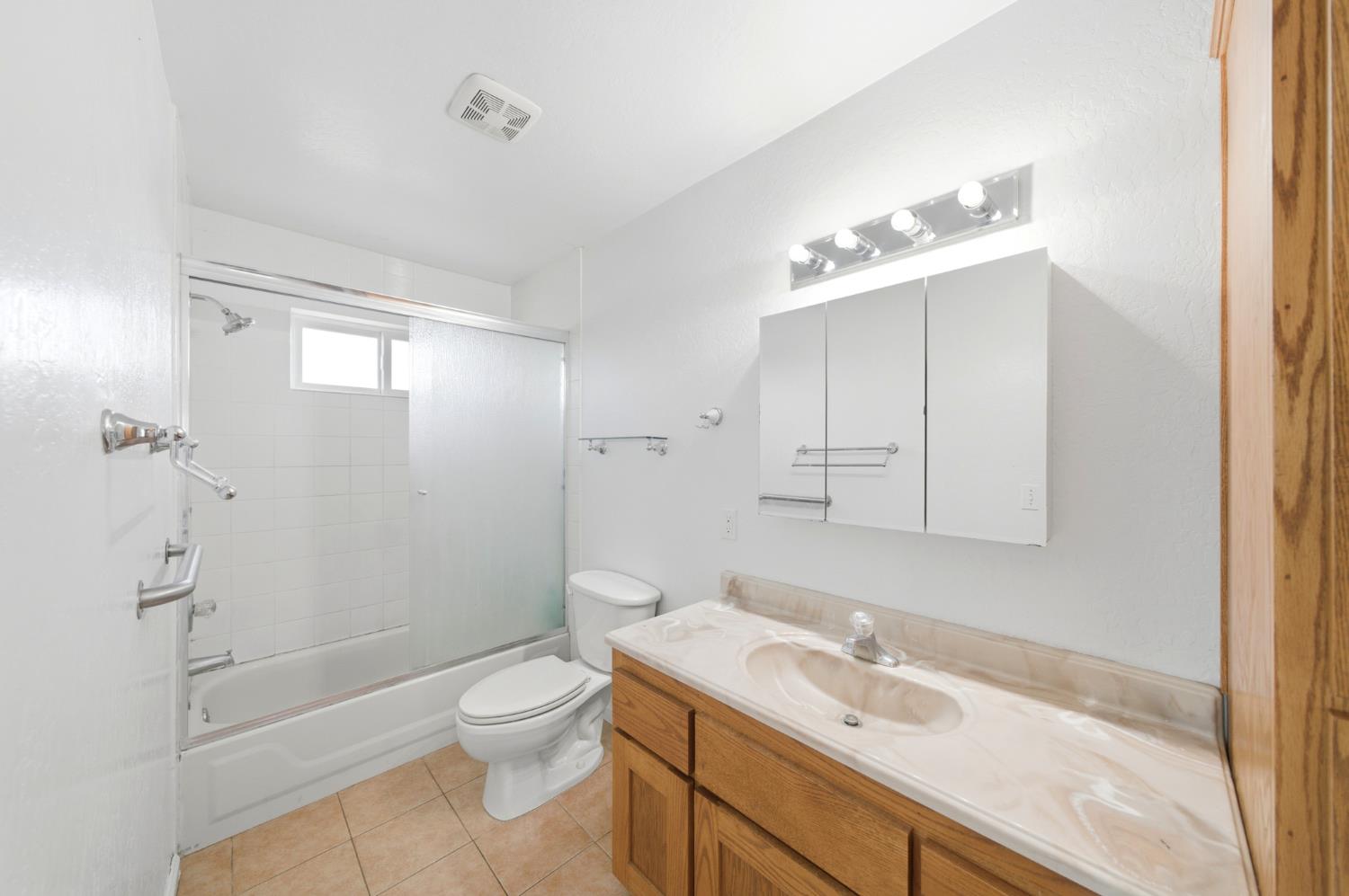6515 West 4th Street Rio Linda, CA 95673 - Photo 40 of 97 a bathroom with a granite countertop sink a toilet and shower