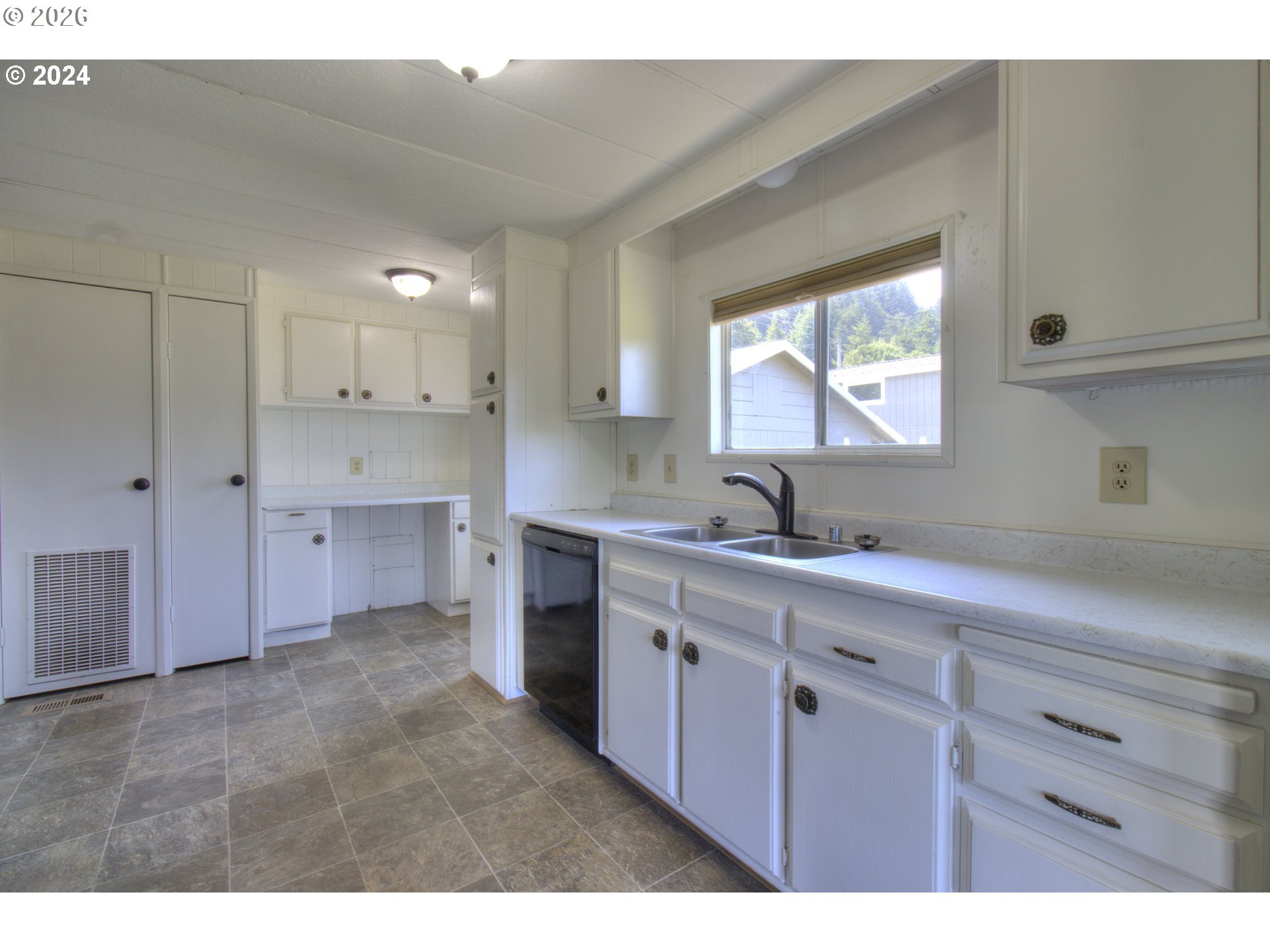 95171 Vista Loop Gold Beach, OR 97444 - Photo 9 of 35 a kitchen with a sink cabinets and window