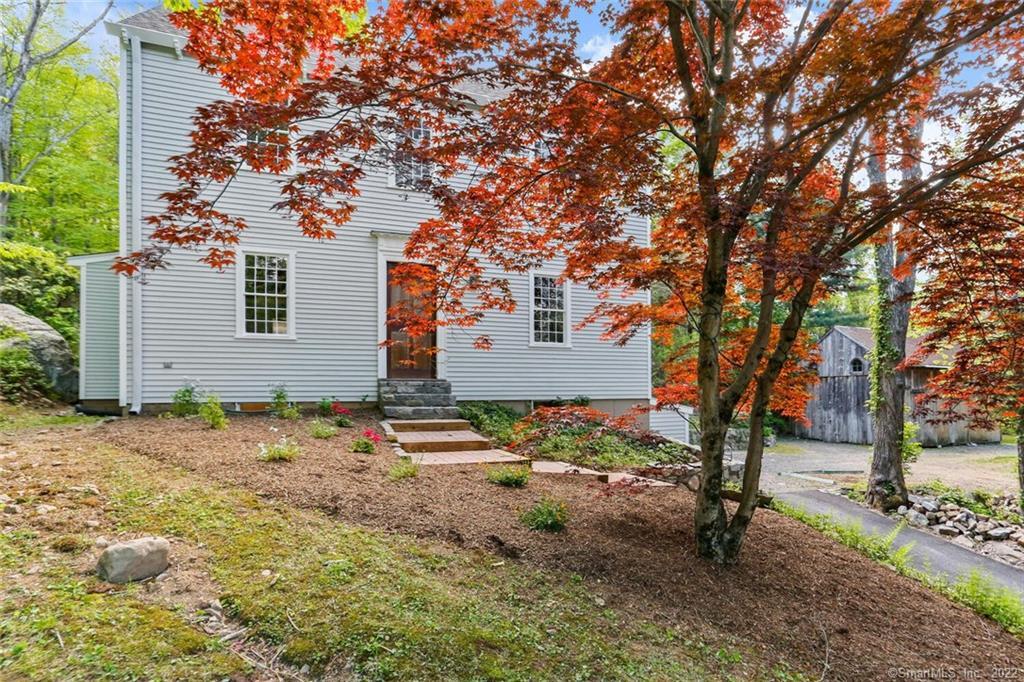 139 Mountain Road Redding, CT 06896 - Photo 1 of 1 a backyard of a house with table and chairs