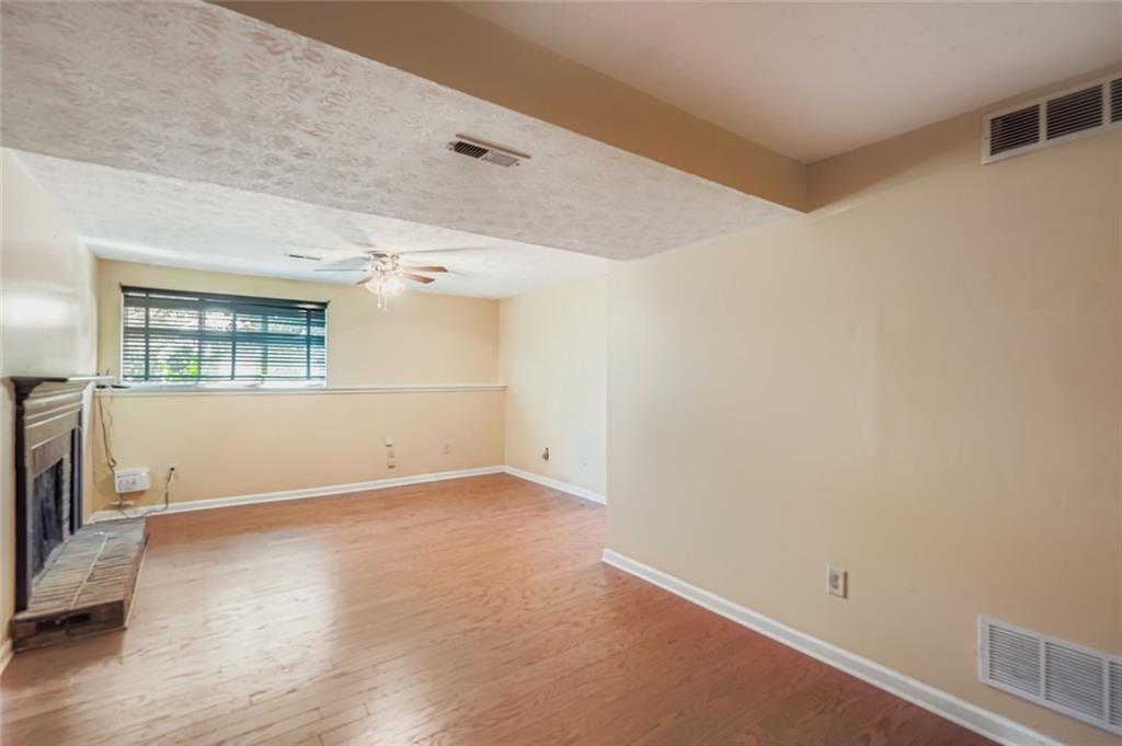 6134 Raintree Bend Lithonia, GA 30058 - Photo 14 of 17 an empty room with a windows and wooden floor