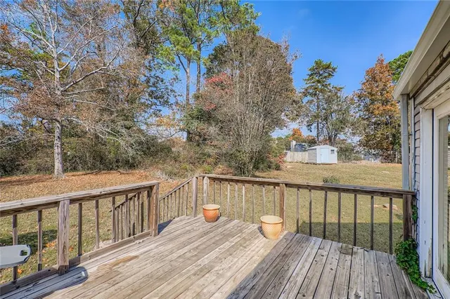 a balcony with wooden floor and wooden fence