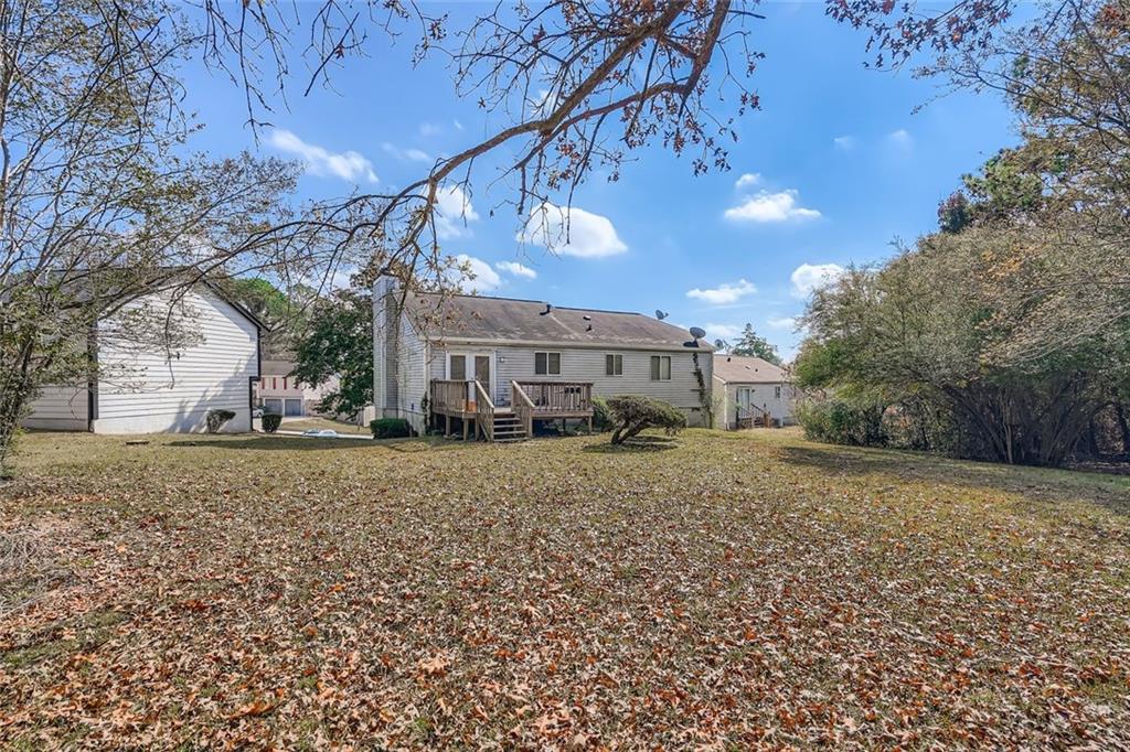 6134 Raintree Bend Lithonia, GA 30058 - Photo 17 of 17 a view of a house with a yard