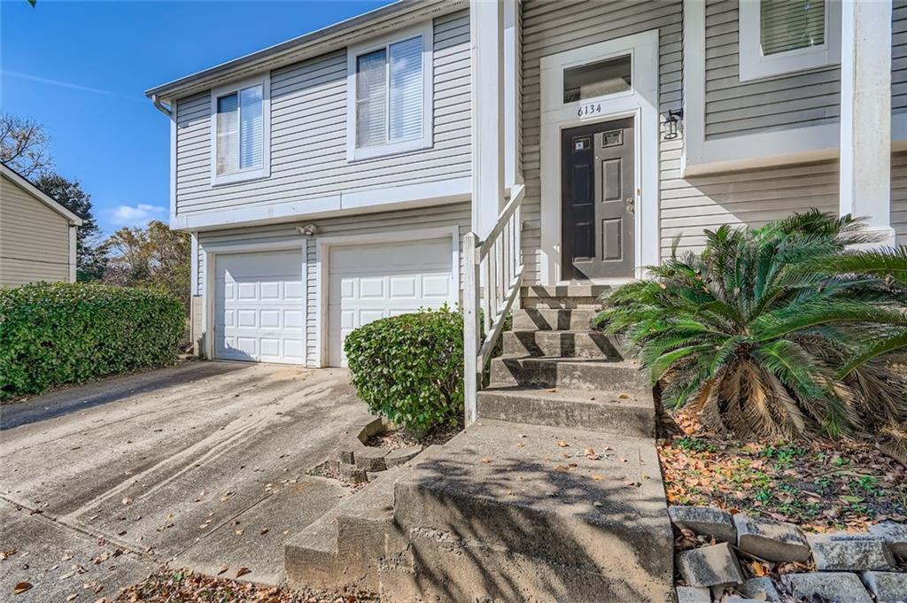 6134 Raintree Bend Lithonia, GA 30058 - Photo 2 of 17 a view of a house with a yard and plants