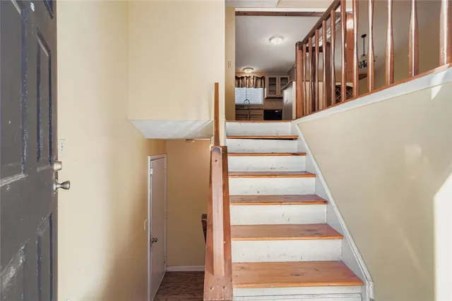 a view of staircase with white walls and a window