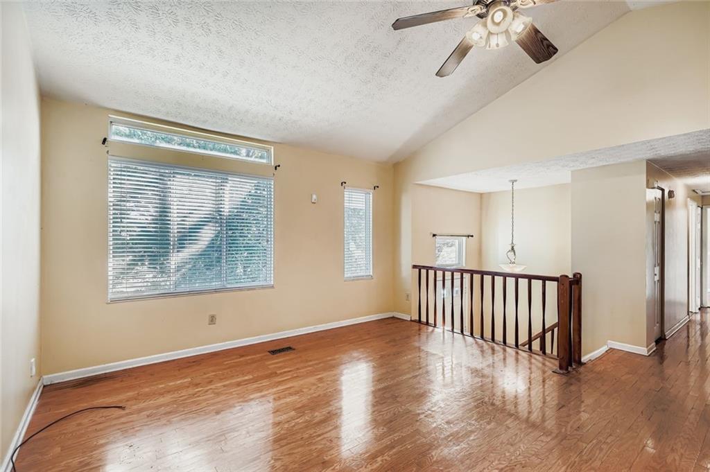 6134 Raintree Bend Lithonia, GA 30058 - Photo 4 of 17 a view of an empty room with wooden floor and a window