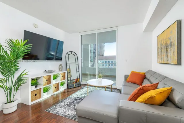 a living room with furniture and a potted plant