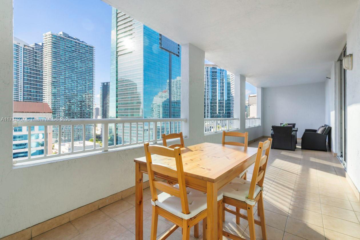 170 Southeast 14th Street, Unit 1905 Miami, FL 33131 - Photo 14 of 17 a dining room with furniture and window