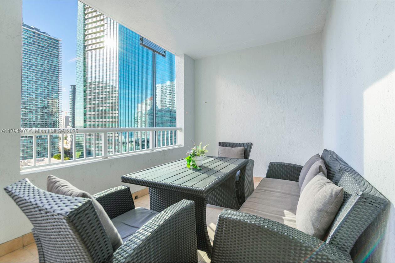 170 Southeast 14th Street, Unit 1905 Miami, FL 33131 - Photo 16 of 17 a view of a dining room with furniture and window