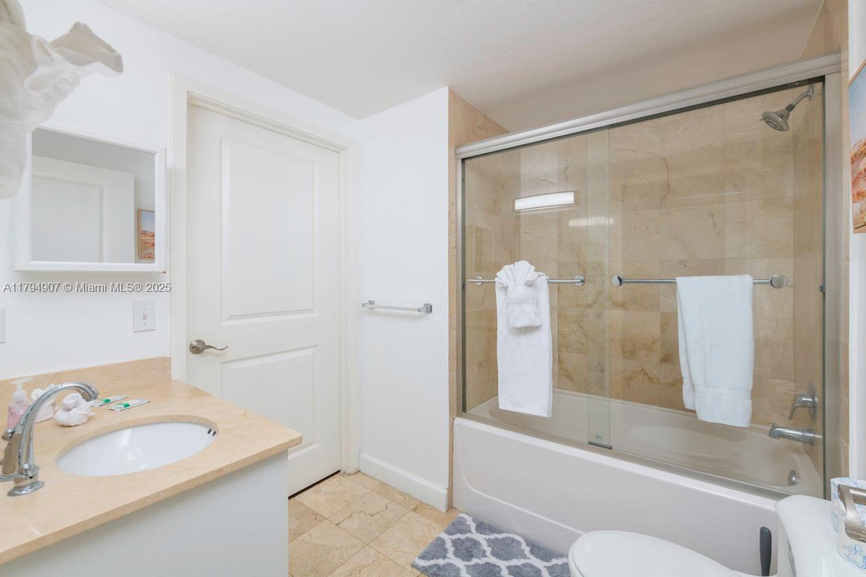 170 Southeast 14th Street, Unit 1905 Miami, FL 33131 - Photo 7 of 17 a bathroom with a sink and a mirror