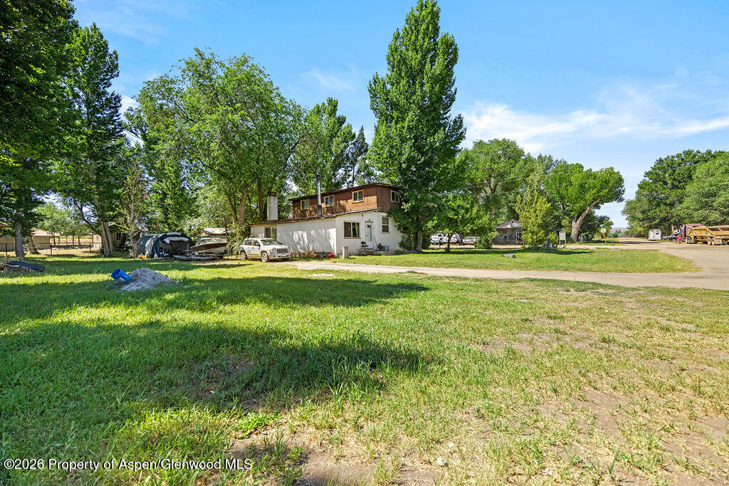a house view with a big yard