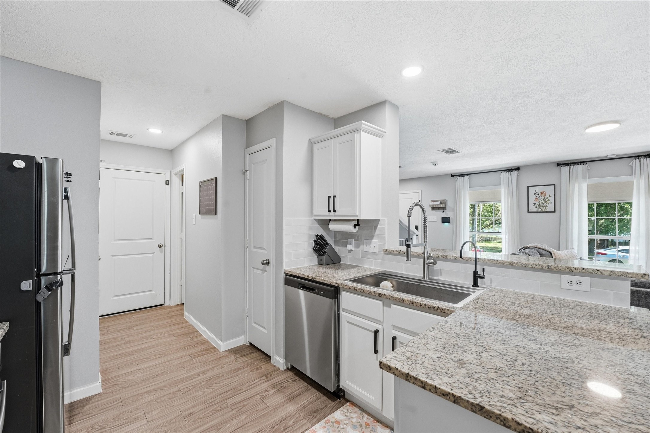 15011 Crockett Road Willis, TX 77378 - Photo 8 of 24 Convenient layout connecting kitchen to pantry, laundry room, and garage entry.