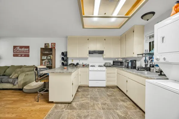 a kitchen with stainless steel appliances granite countertop a refrigerator sink and cabinets