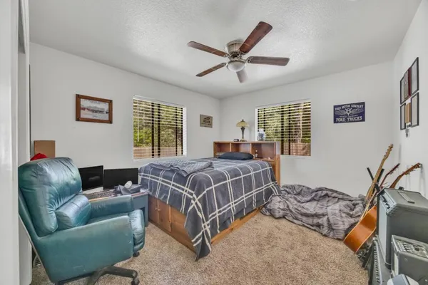 a bedroom with a bed couch and window