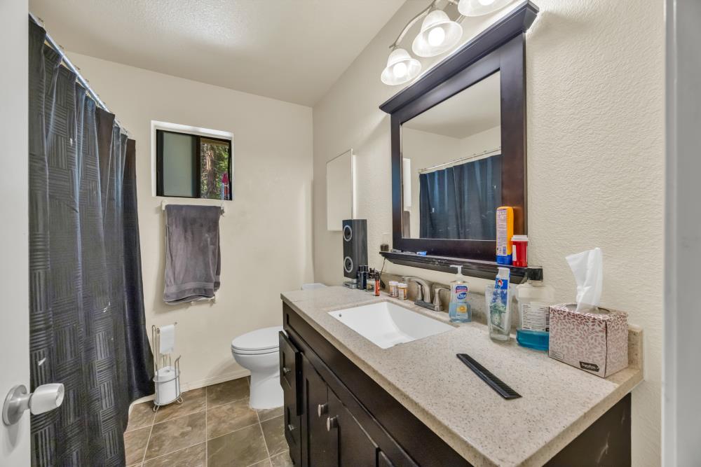 2960 Backpack Trail Pollock Pines, CA 95726 - Photo 17 of 49 a bathroom with a sink vanity mirror and toilet