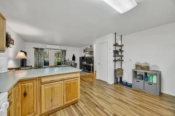 a spacious bathroom with stainless steel appliances granite countertop a sink and wooden floor