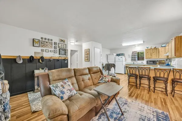 a living room with furniture and wooden floor