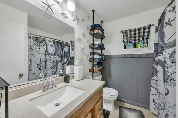 a bathroom with a sink toilet and shower
