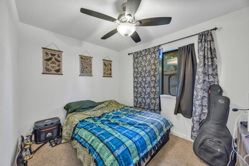 2960 Backpack Trail Pollock Pines, CA 95726 - Photo 32 of 49 a bedroom with a bed and a chandelier