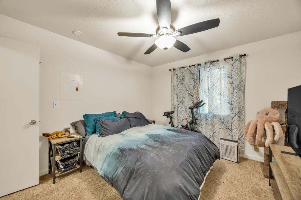 2960 Backpack Trail Pollock Pines, CA 95726 - Photo 34 of 49 a bedroom with a bed and a chandelier