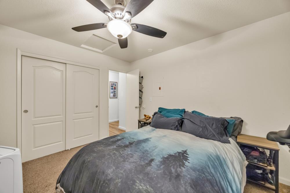 2960 Backpack Trail Pollock Pines, CA 95726 - Photo 35 of 49 a bedroom with a bed and a chandelier