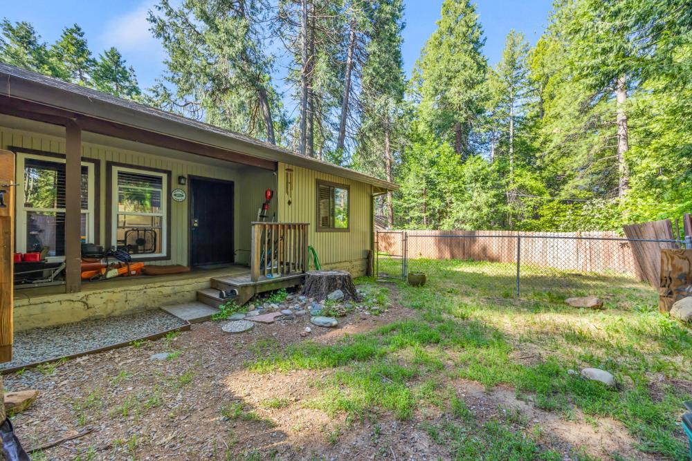2960 Backpack Trail Pollock Pines, CA 95726 - Photo 4 of 49 a view of a backyard with table and chairs and potted plants