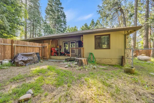 a backyard of a house with yard and outdoor seating
