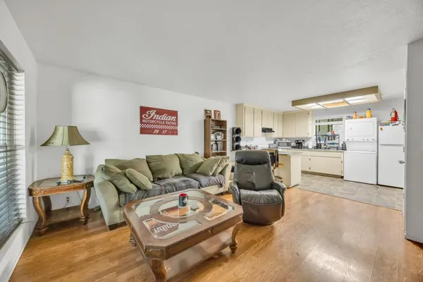 a living room with furniture and kitchen view