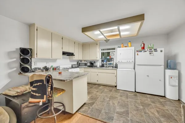 a storage room with cabinets washer and dryer