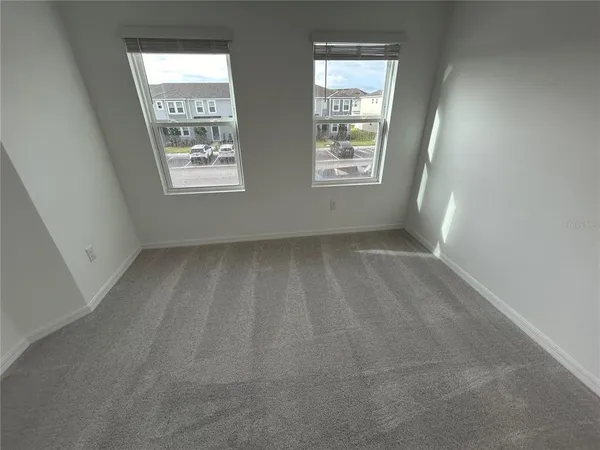 a view of an empty room with windows