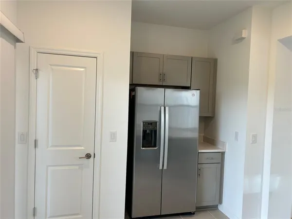 a metallic refrigerator freezer sitting in a kitchen