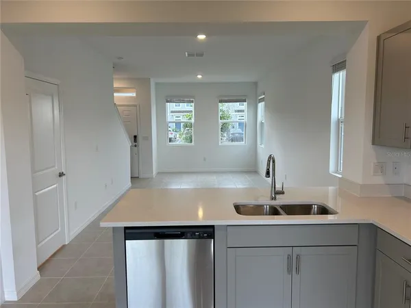 a kitchen with a sink cabinets and window