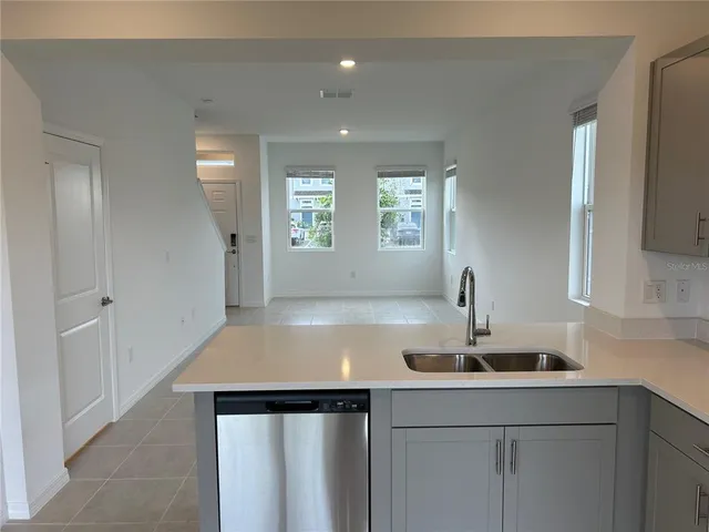 a kitchen with a sink cabinets and window