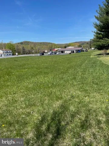 a view of a field with an outdoor space and seating