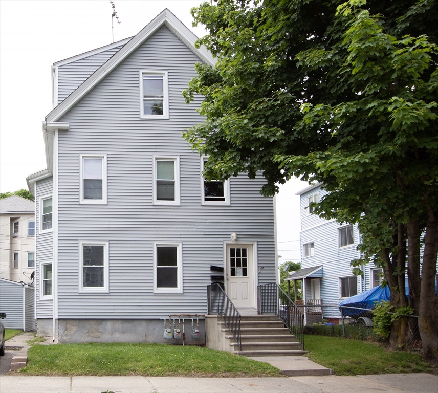 a front view of a house with a yard