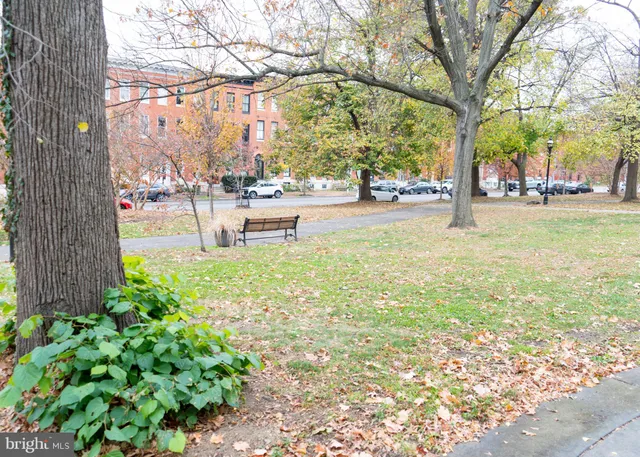 a view of a building with a garden and pathway