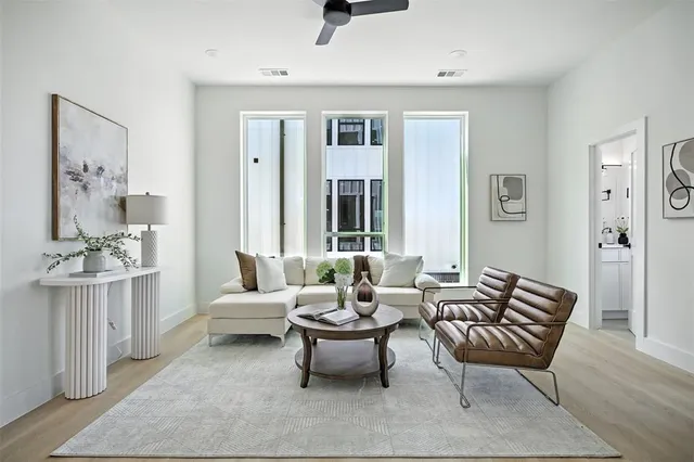 a living room with furniture and a potted plant