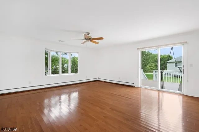 a view of a livingroom with wooden floor and a window