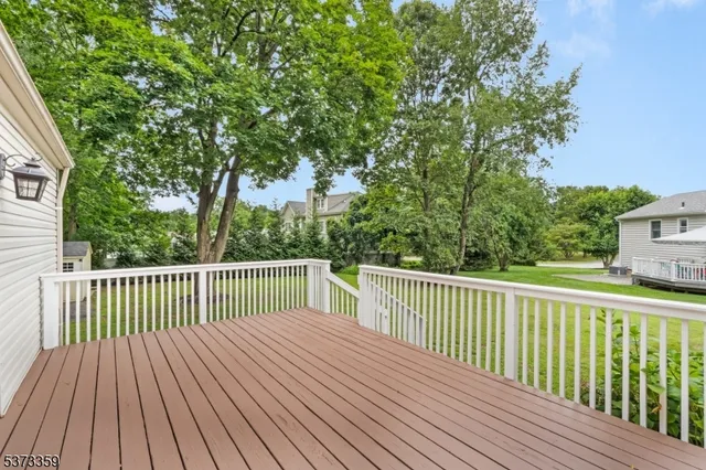 a balcony with wooden floor and trees