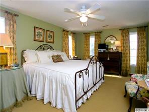 905 Concord Road Davidson, NC 28036 - Photo 11 of 15 a bedroom with a bed mirror and a window
