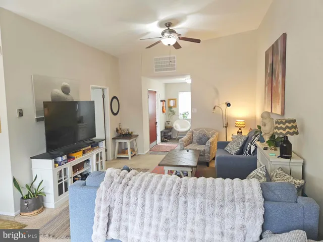 a bedroom with a bed dresser and a flat tv screen