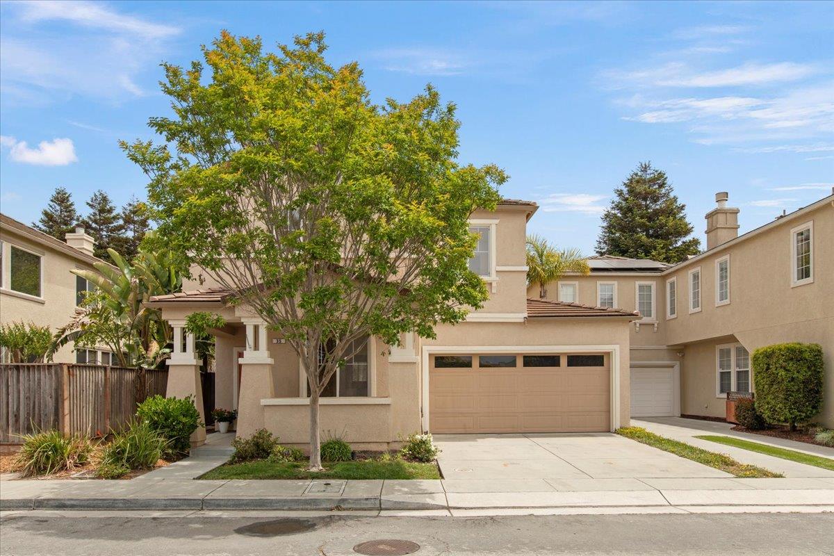 a front view of a house with a garden
