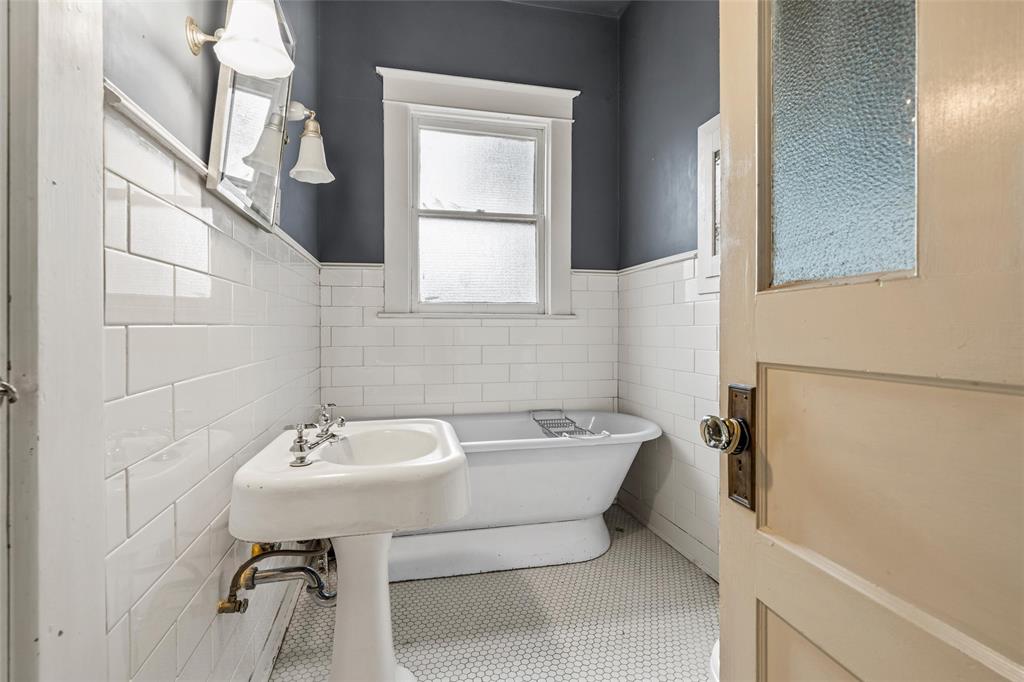 2717 Colcord Avenue Waco, TX 76707 - Photo 14 of 34 a bathroom with a sink a toilet and mirror