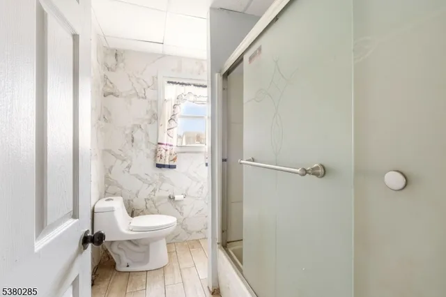 a white toilet sitting next to a bathroom sink
