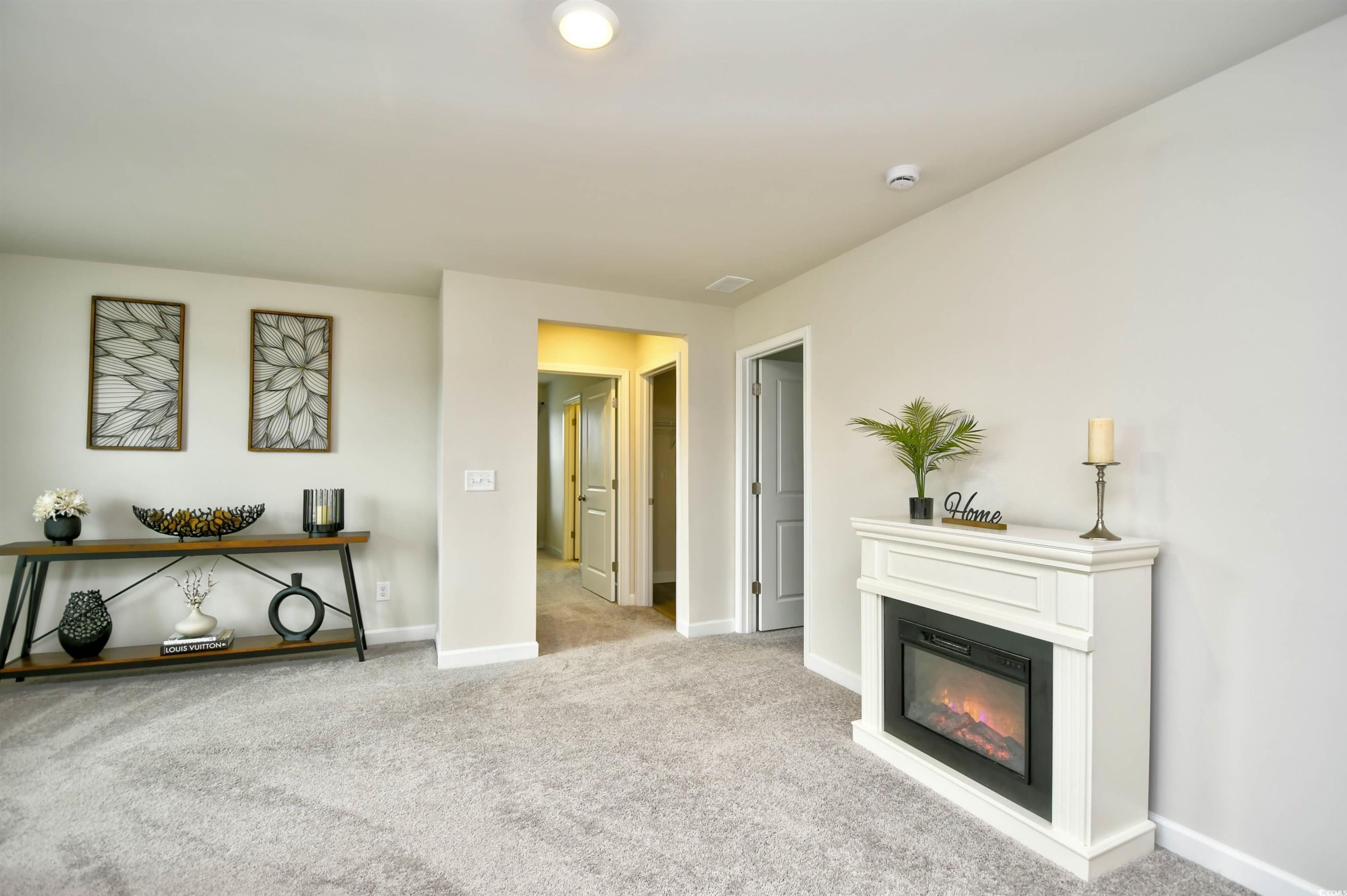 2325 Copper Crk Loop Longs, SC 29568 - Photo 18 of 40 Sitting room with carpet floors and a glass covered fireplace